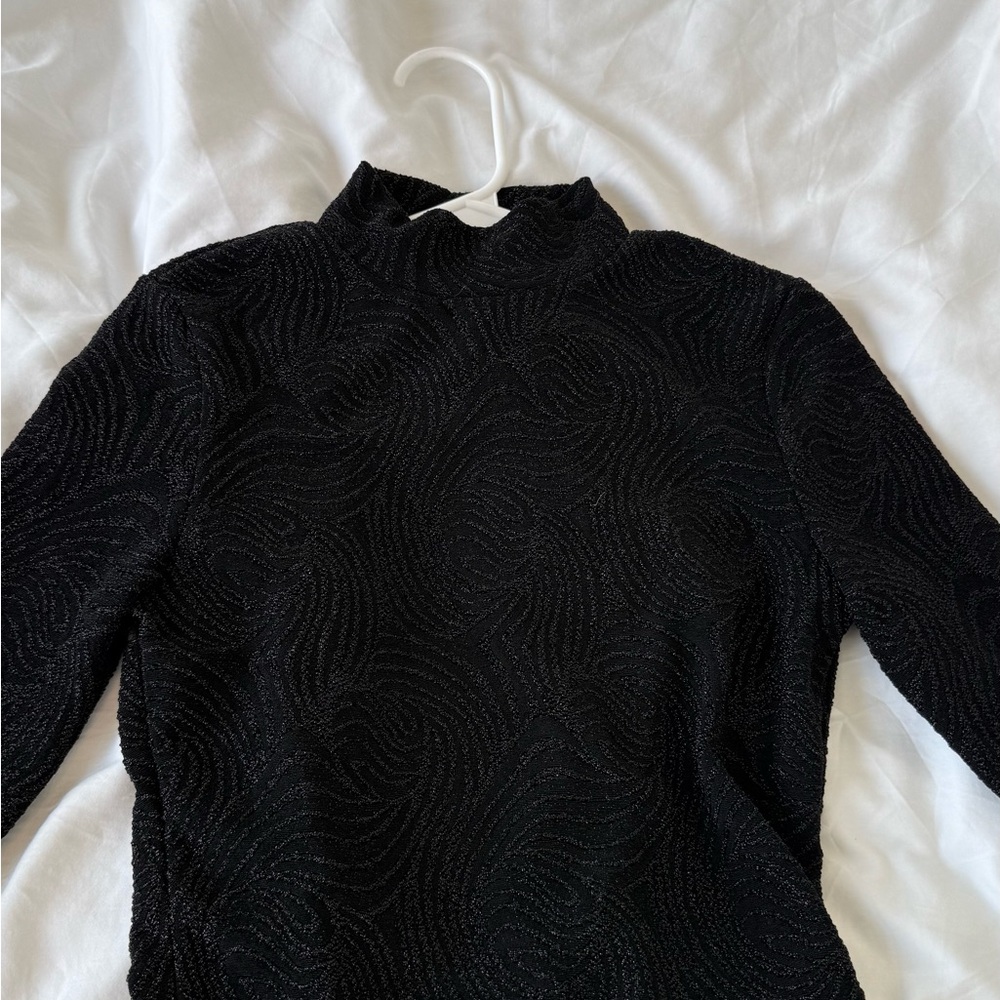 Black patterned turtleneck long sleeve with cut out in back